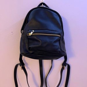 Miniature black backpack with adjustable straps